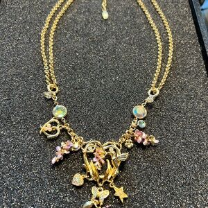 Kirk’s Folly necklace with Hummingbird, grapes, butterfly, heart, and stars.